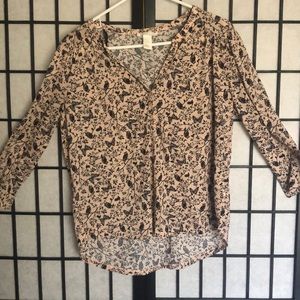 A baby pink blouse with a nature design